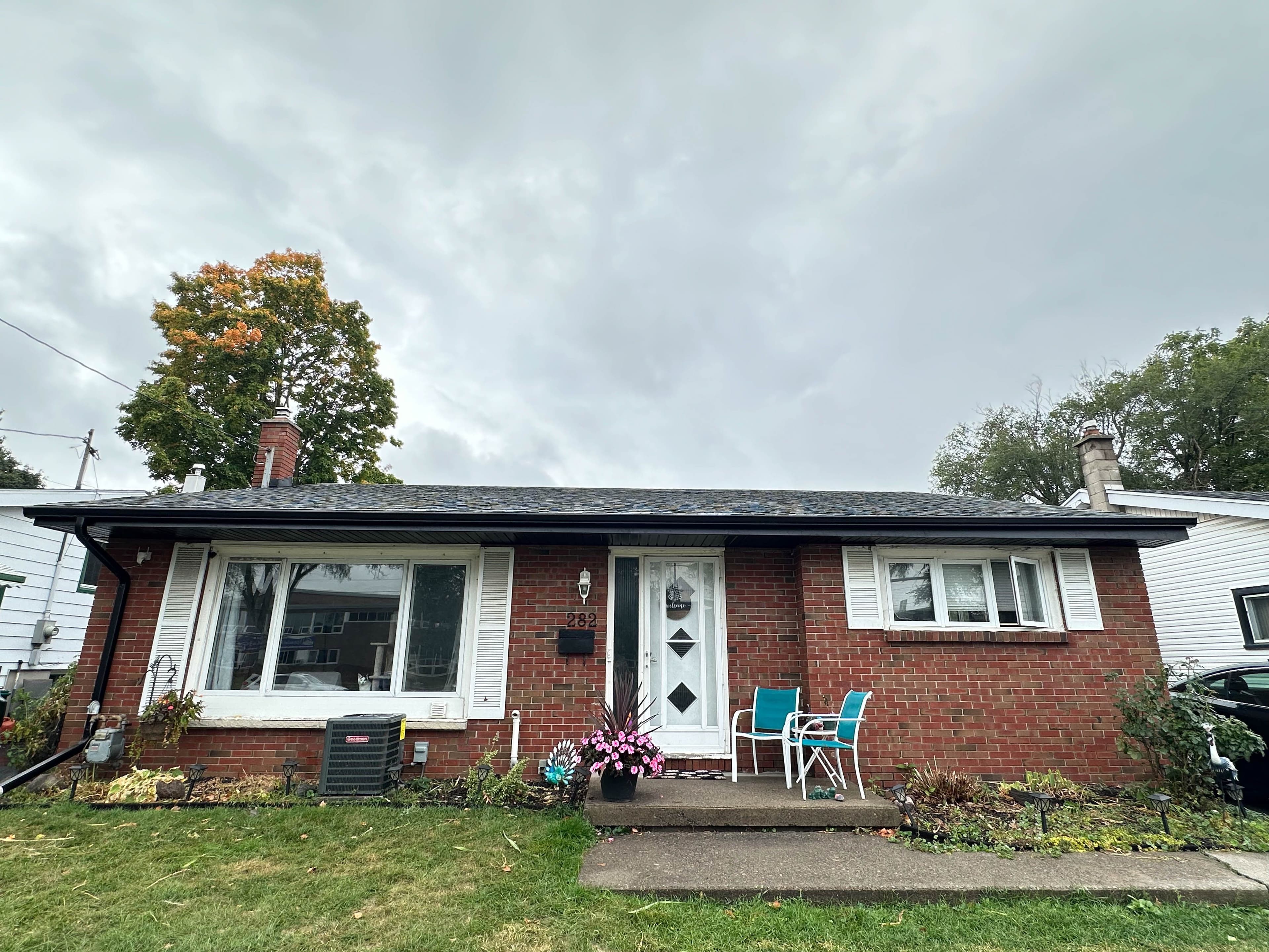 Front view of a Belleville brick home featuring new fascia, soffit, and eavestrough installed by Ravix Custom Exteriors