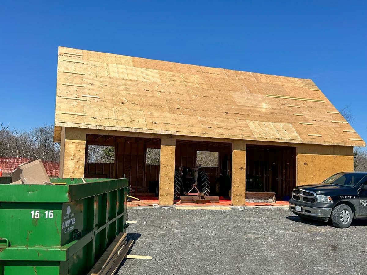 Modern building with textured charcoal standing seam metal roof and Gentek Moderno steel wood grain siding in Roseneath