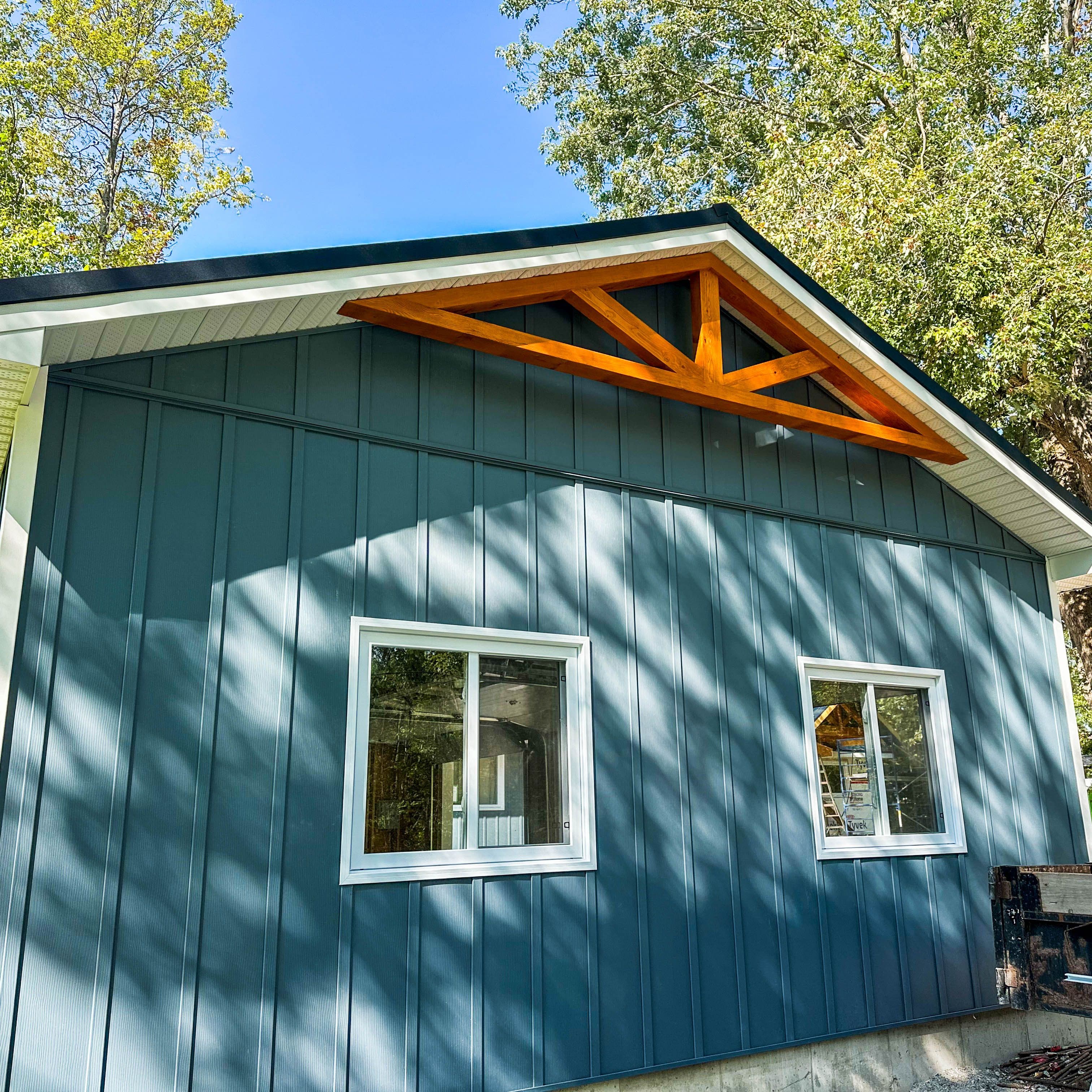 Side view of Fenelon Falls home with Gentek Align composite board and batten siding and timber gable accent